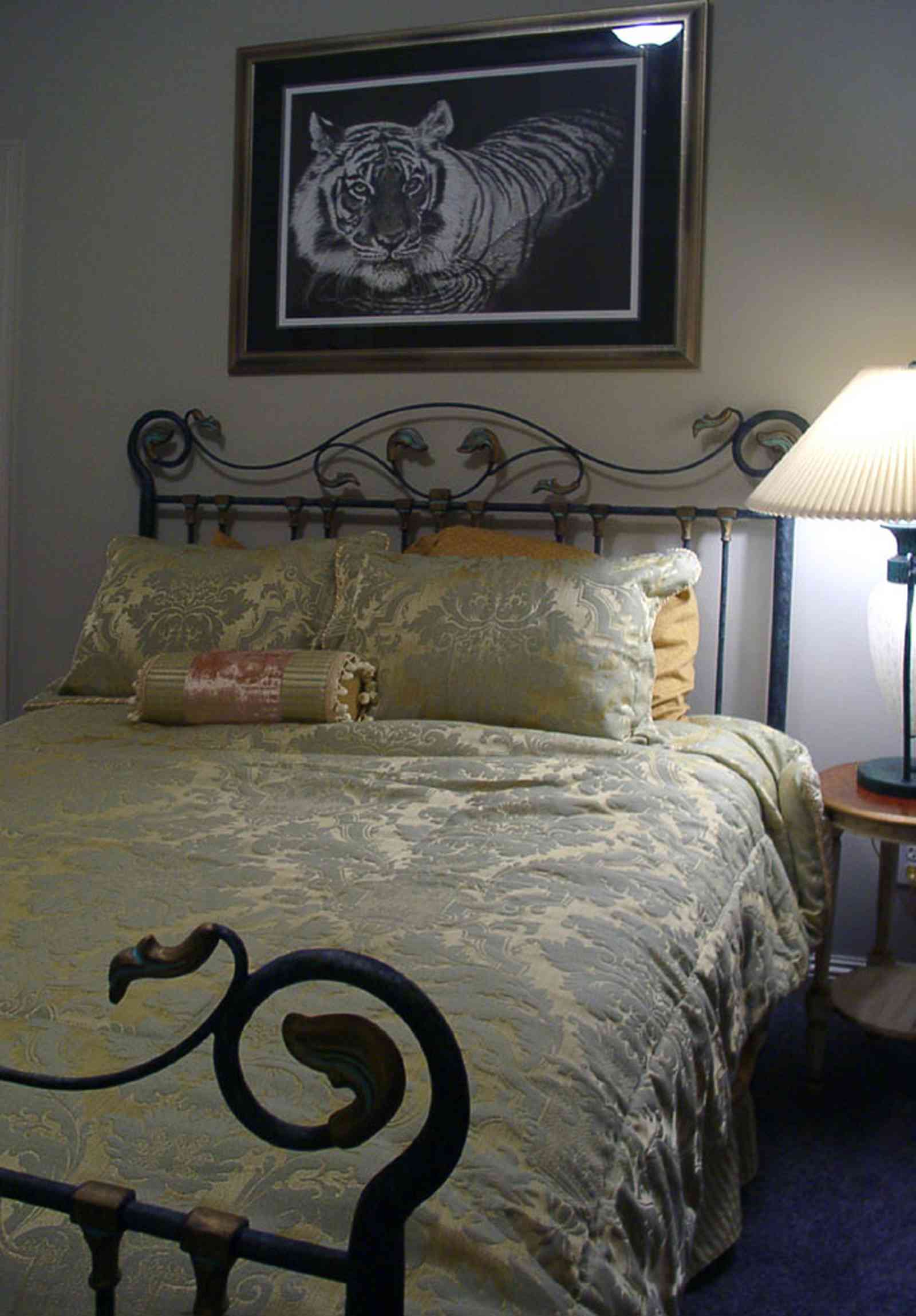Aragon:-591-Aragon-Street_26.jpg:  wrought-iron bed, tiger painting, dee dee ritchie