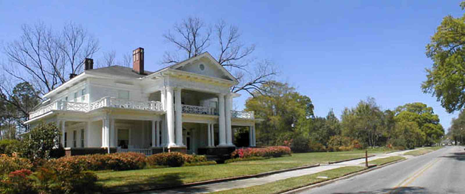 Brewton:-Belleville-Avenue_04.jpg:  victorian mansion, front porch, greek revival facade, classical revival, columns, azalea bushes, turret, colonnade