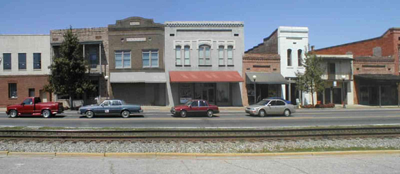 Brewton:-Downtown_00a.jpg:  store front facades, railroad tracks, main street america, 1920\