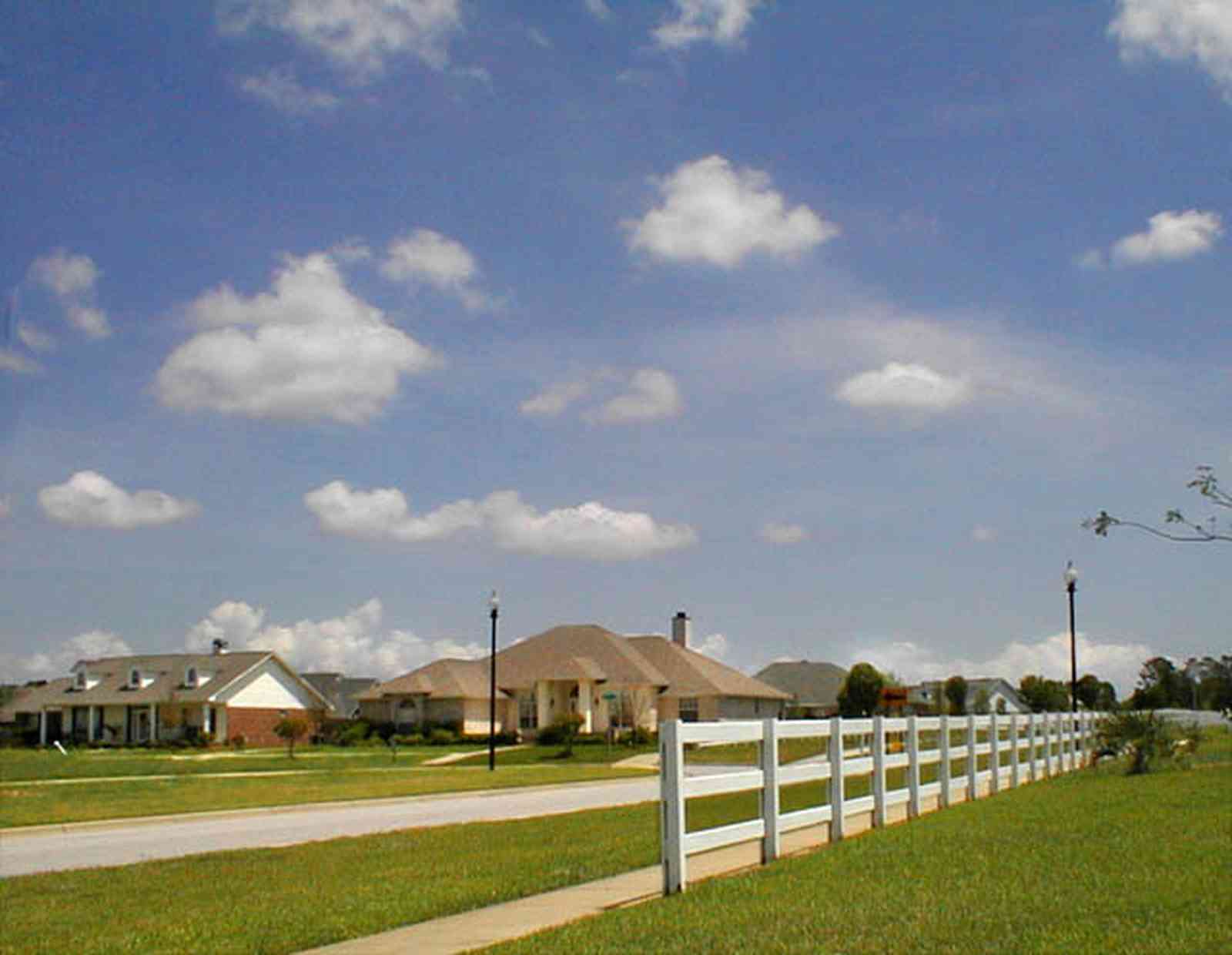 Cantonment:-Milestone_23.jpg:  cumulus clouds, oak trees, boulevard, tract houses, white board fence,  garden