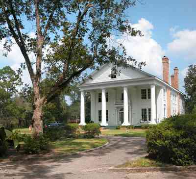 Century:-Tannenheim_02b.jpg:  victorian mansion, southern mansion, white columns, heart pine wood, tongue and groove walls, pasture, lake pecan orchard, plantation, rolling pastures, timber, hedge, azalea bush, country road