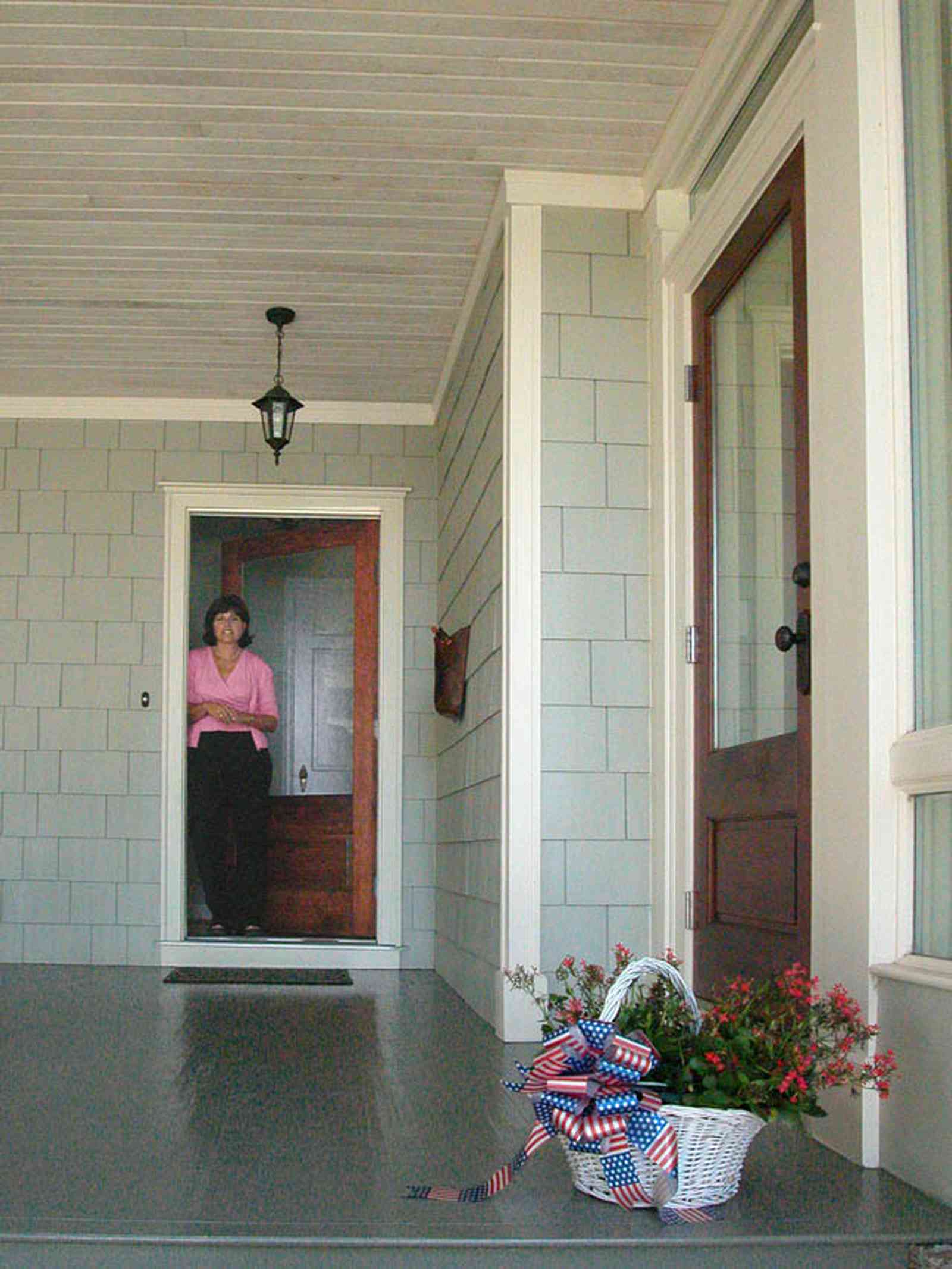 East-Hill:-2109-Whaley-Drive_03a.jpg:  front door, shingle siding, wooden porch floor, basket of flowers, beaded wooden ceiling