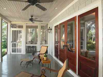 East-Hill:-2109-Whaley-Drive_09.jpg:  ceiling fan, beaded wooden ceiling, screen porch, wicker chairs, bayou view