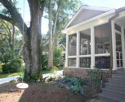 East-Hill:-2109-Whaley-Drive_12.jpg:  oak tree, tree swing, front porch, screen porch, ranch style home, bayou