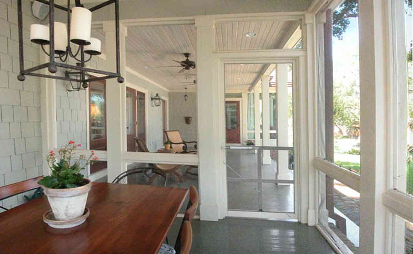 East-Hill:-2109-Whaley-Drive_14.jpg:  dining table, screen porch, wrought-iron lantern, wood shingles, ceiling fan, front porch