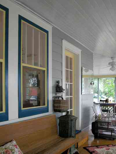East-Pensacola-Heights:-600-Bayou-Blvd_05.jpg:  front porch, pine bench, heartpine floor, wicker furniture, french door, floral cushion