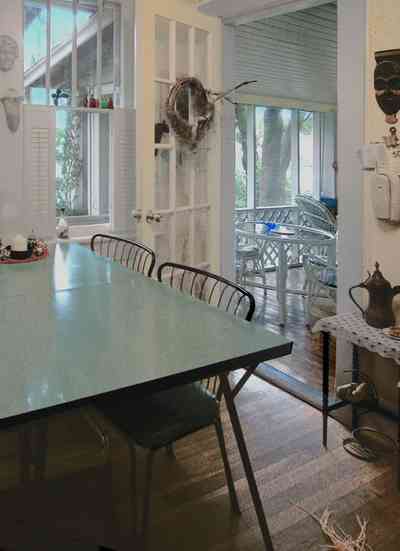 East-Pensacola-Heights:-600-Bayou-Blvd_21.jpg:  dining room, screened-in porch, shutters, french door, bayou view