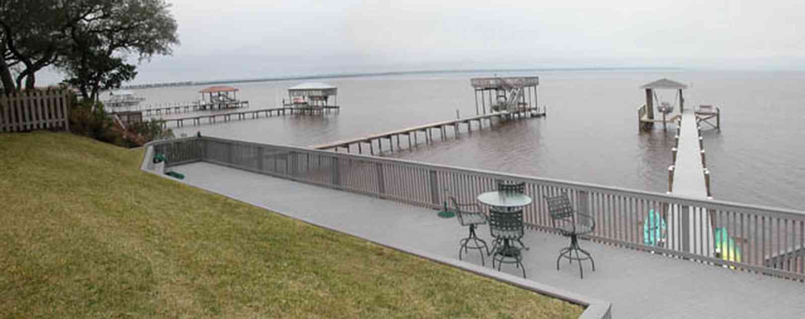 Gulf-Breeze:-228-North-Cliff-Dr_08.jpg:  swimming pool, bay, dock, pier, deck, flag pole, boat, bayfront
