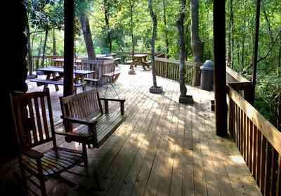 Milton:-Adventures-Unlimited_07.jpg:  rocking chair, swing, picnic table, deck, pier, swamp