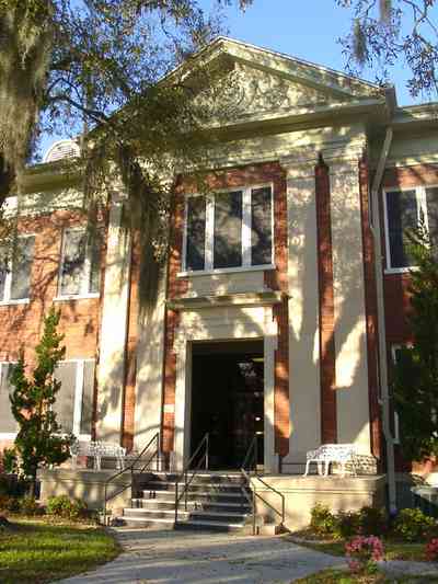 Milton:-Canal-Street-School_03.jpg:  school building, classical revival architectural style, red brick schoolhouse, wrought iron furniture, spanish moss, oak tree