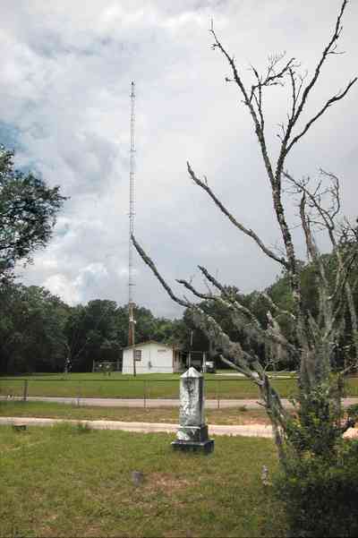 Milton:-WECM_01.jpg:  tombstone, radio tower, spanish moss, marble grave marker, dead tree, a.m. station, christian radio station