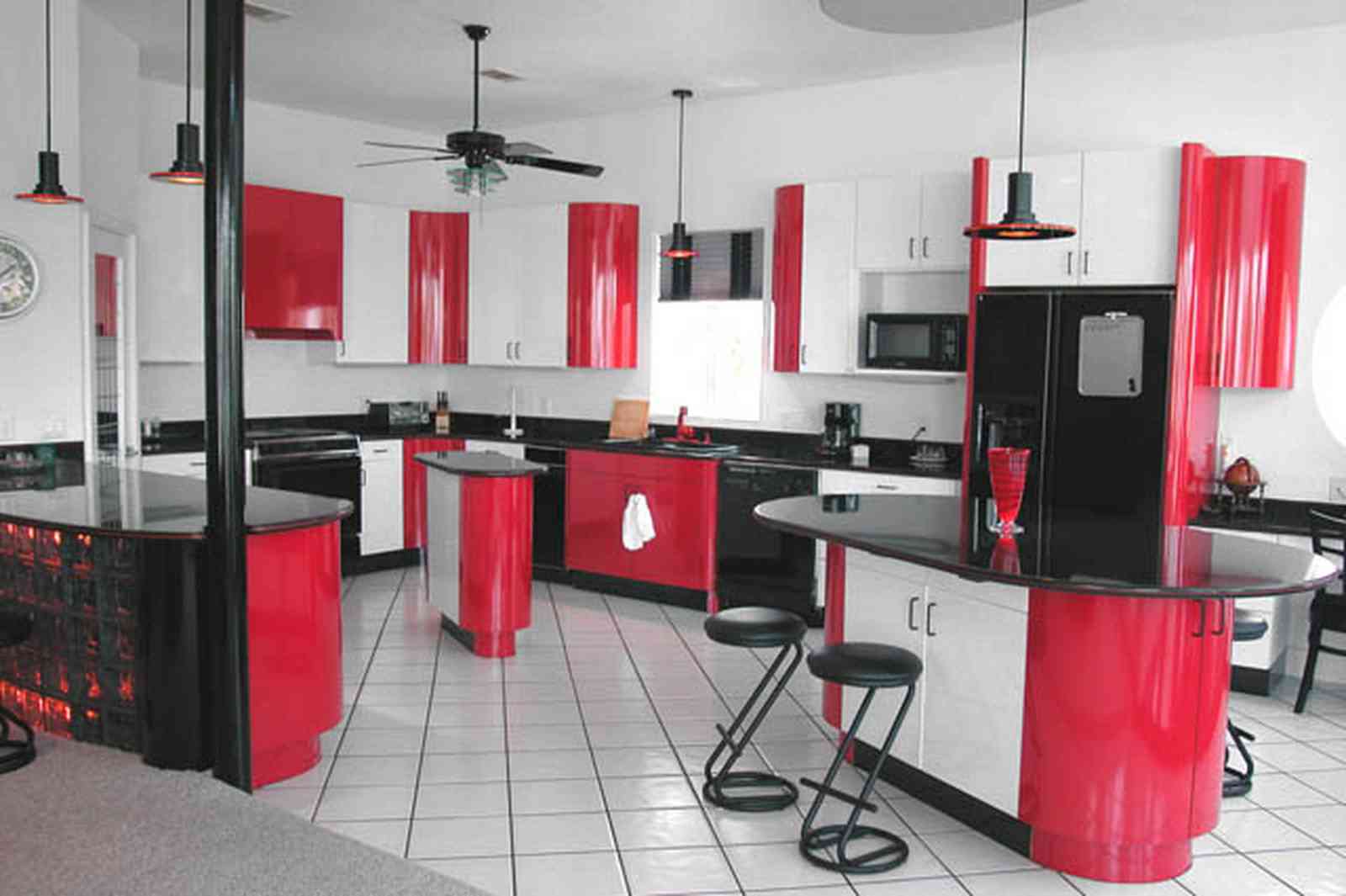 Navarre:-7332-Grand-Navarre-Blvd_21.jpg:  red lacquer cabinets, red and black, art deco decor, art deco house, kitchen, red kitchen cabinets, glass brick bar, ceiling fan, black laquer cabinets