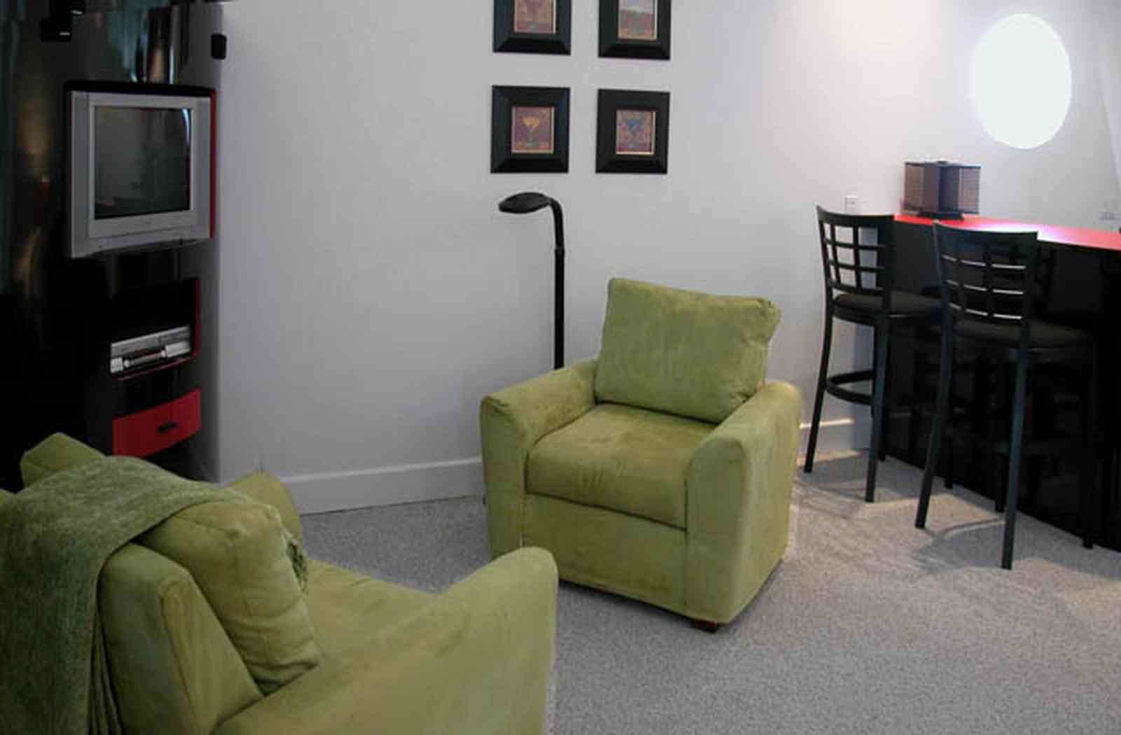 Navarre:-7332-Grand-Navarre-Blvd_28.jpg:  green suede chairs, entertainment center, bar, den, red laquered bar