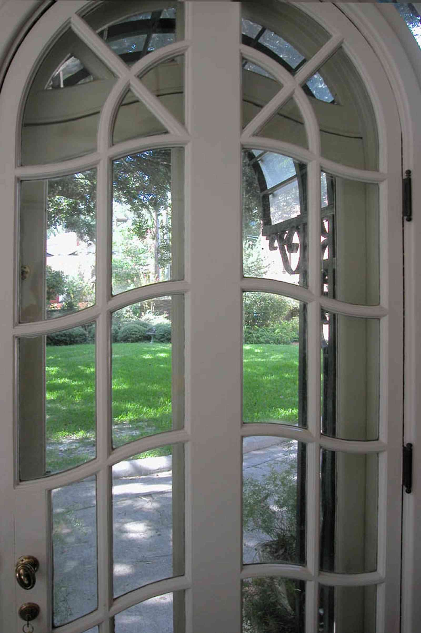 North-Hill:-105-West-Gonzales-Street_08a.jpg:  french door, leaded glass panes, archway, double door, entrance, florida sunroom
