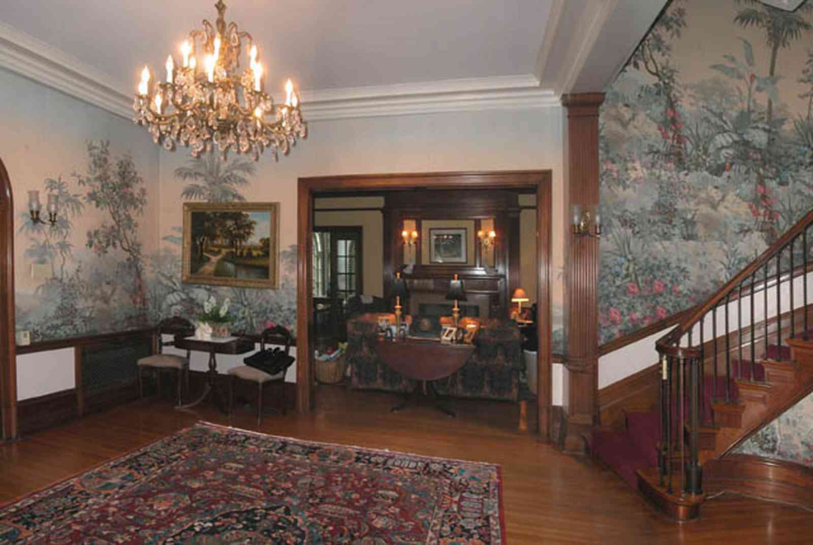 North-Hill:-105-West-Gonzales-Street_25.jpg:  grand foyer, oriental rug, spiral staircase, chandelier, hardwood floors, french colonial architecture