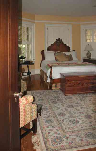 North-Hill:-105-West-Gonzales-Street_63.jpg:  antique bed, cedar chest, oriental rug, shutters, awnings wainscotting, hardwood floor