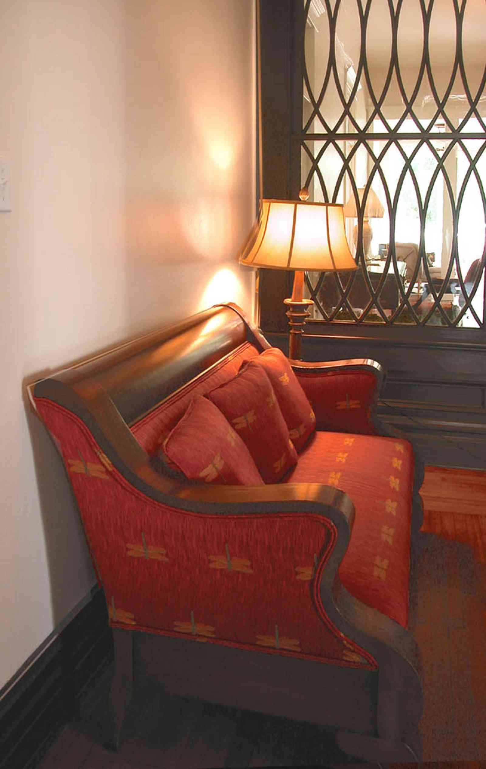 North-Hill:-116-DeSoto-St_02d.jpg:  red brocade sofa, central hall, floor lamp, heartpine flooring