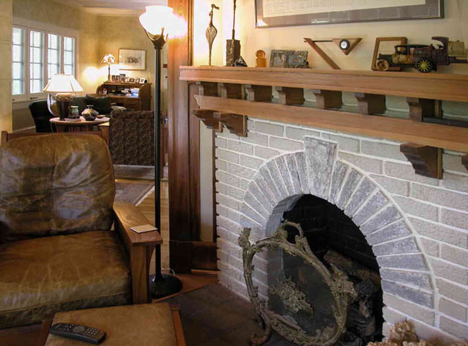 North-Hill:-284-West-Gonzales-Street_16.jpg:  leather chair, stone fireplace, fire screen, wooden mantle, craftsman cottage