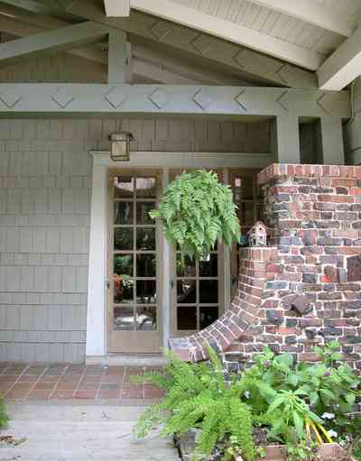 North-Hill:-284-West-Gonzales-Street_24.jpg:  side door, craftsman cottage, brick pillar, exposed beans, red tile sidewalk, ferns, birdhouse