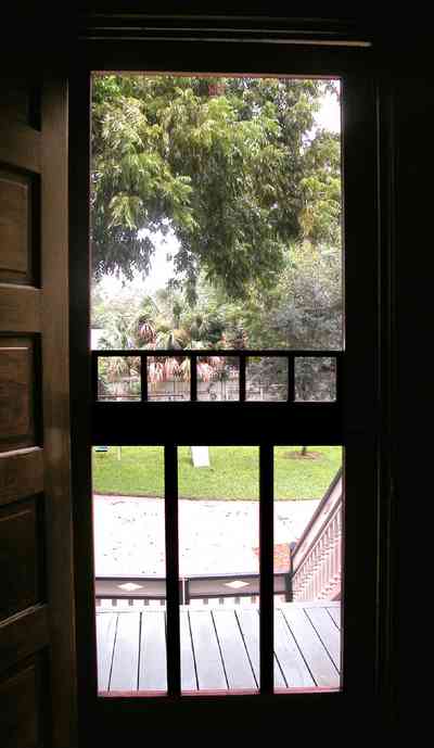 North-Hill:-304-West-Gadsden-Street_10.jpg:  screen door. pecan tree, side porch, heartpine door, north hill preservation district