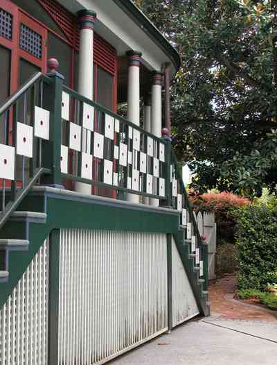 North-Hill:-304-West-Gadsden-Street_25.jpg:  lattice work, columns, porch, screen porch, stucco, magnolia tree, picket fence