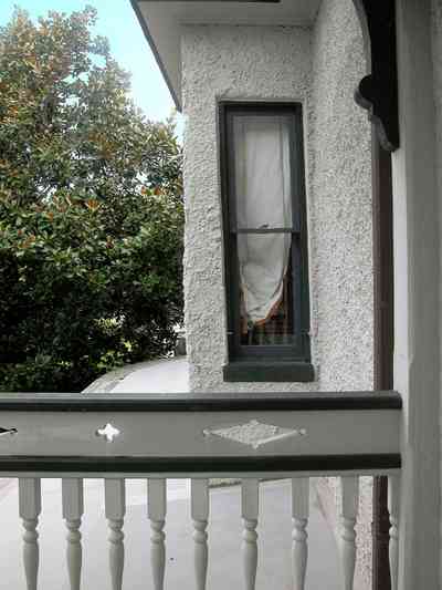 North-Hill:-304-West-Gadsden-Street_30.jpg:  balcony, stucco wall, magnolia tree, green trim, porch, upstairs