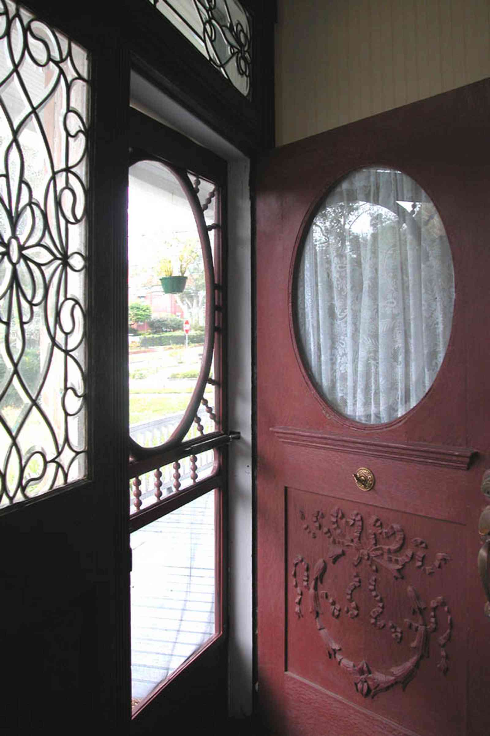 North-Hill:-52-West-Gonzalez-Street_05.jpg:  front door, beveled glass, screen door, oval window, fret work, door carvings, victorian home, transom
