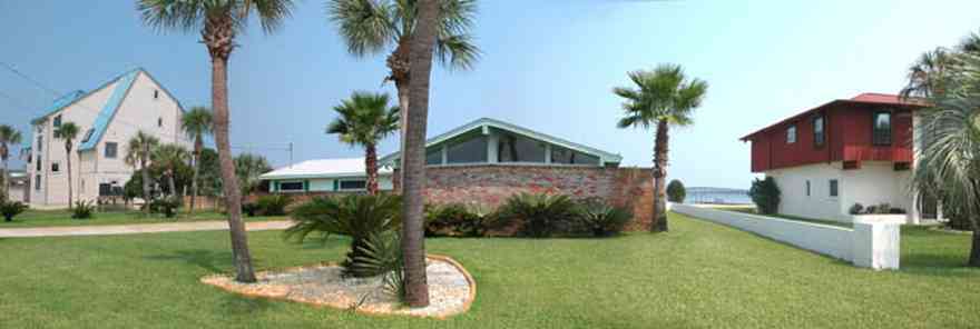 Pensacola-Beach:-231-Sabine-Drive_01.jpg:  palm trees, 1950's architecture, brick house, pensacola bay, soundside