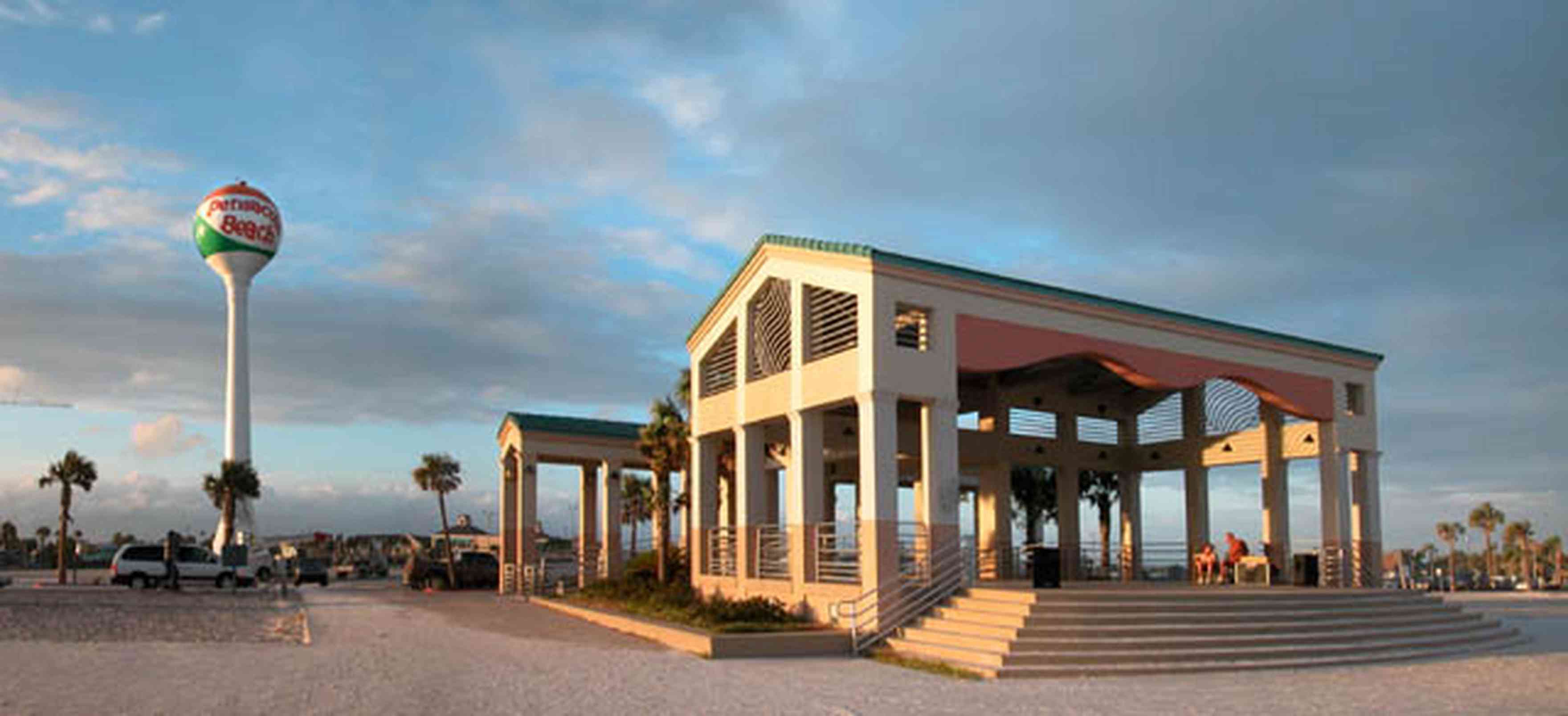 Pensacola-Beach:-Casino-Beach-Pavillion_01.jpg:  open-air pavillion, gathering place, temple, shelter, columns, steps, beach ball, water tower, palm trees, beachfront, sand