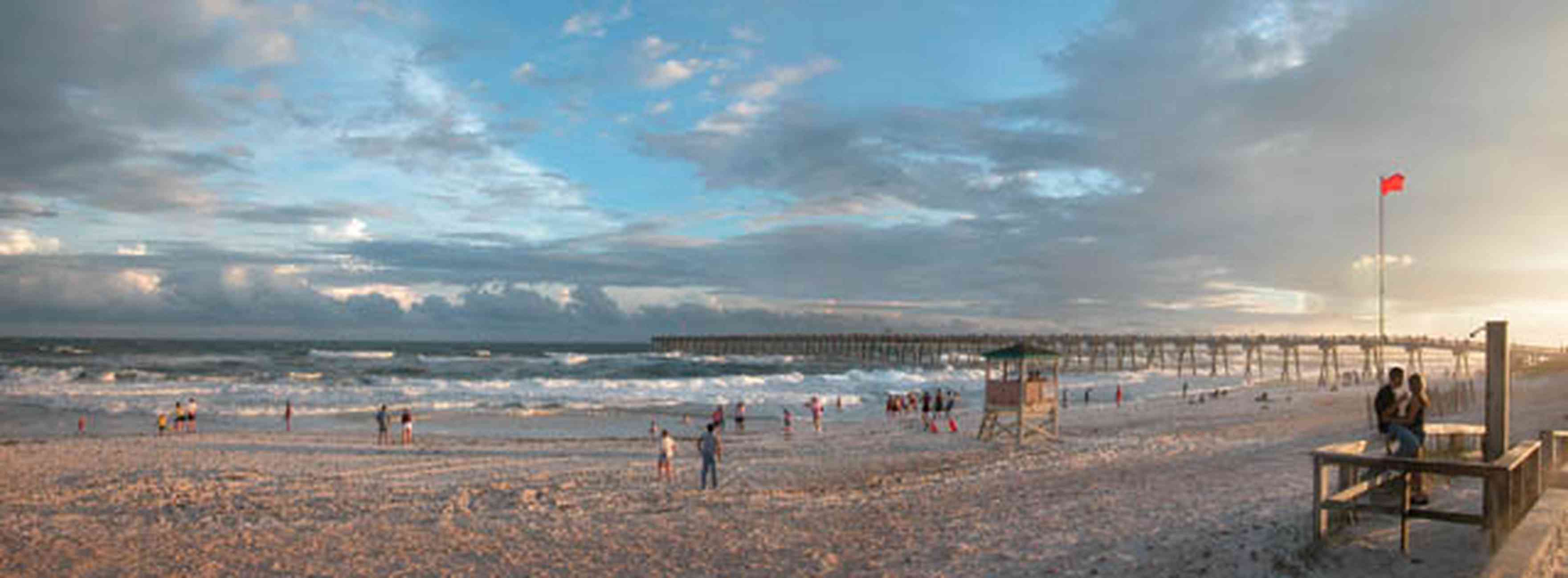 Pensacola-Beach:-Casino-Beach_01-copy.jpg:  beach front, surf, red flag, high surf, waves, lifeguard, swimmers, fishing pier, gulf of mexico, storm clouds, tropical storm, mixed skies