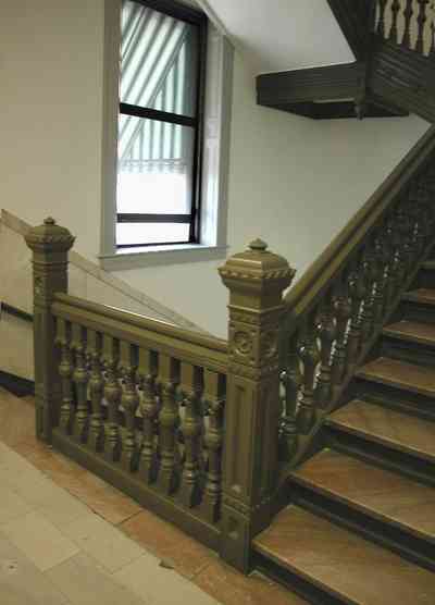 Pensacola:-Palafox-Historic-District:-Escambia-County-Courthouse_09b.jpg:  marble floor, marble walls, oak table, foyer, entrance, courthouse, marble staircase, iron balustrade, public building, 