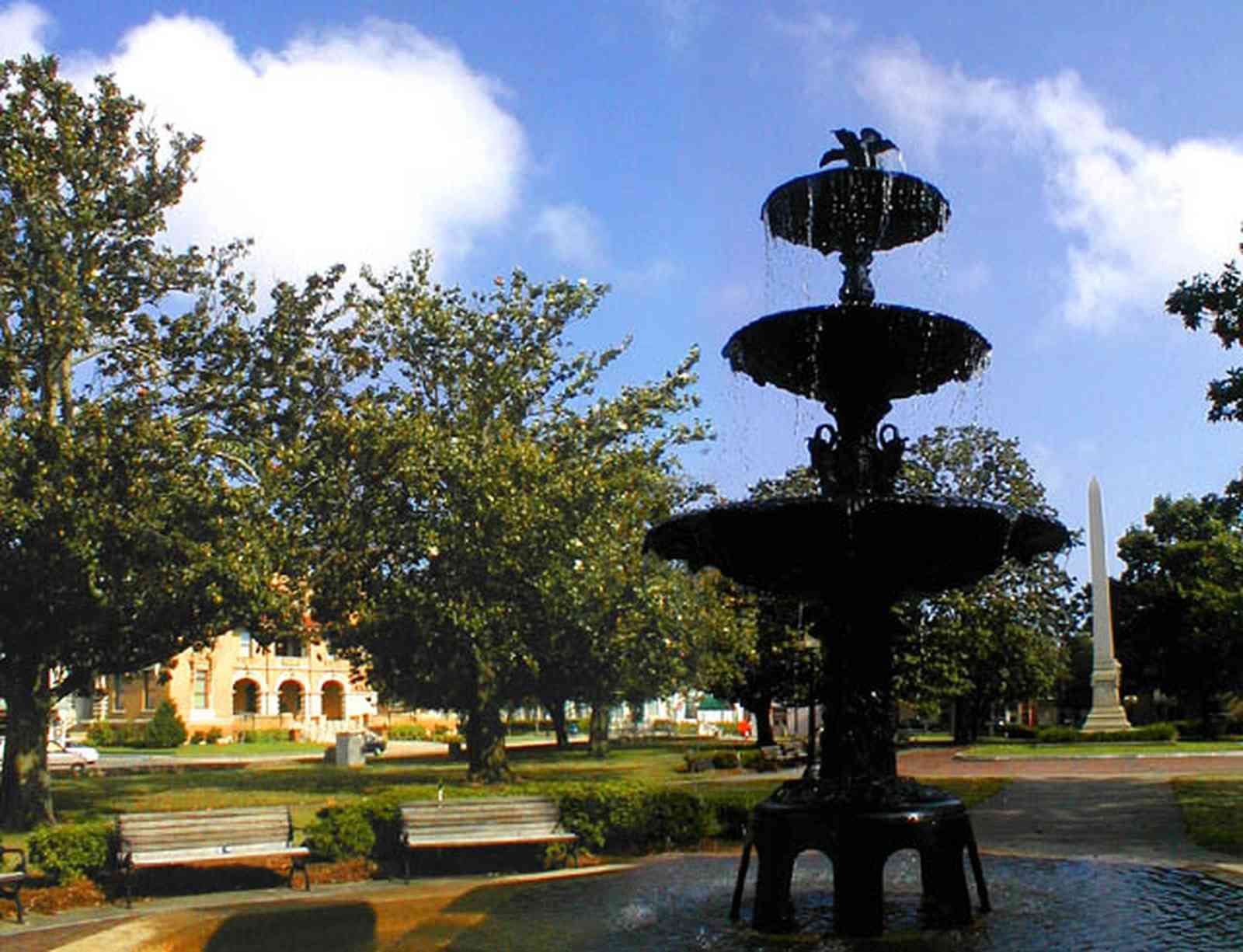 Pensacola:-Palafox-Historic-District:-Ferdinand-Plaza_02.jpg:  town square, plaza, obelisk, stone wall, oak trees, magnolia trees, historic district, courthouse, t. t. wentworth, jr. museum, fountain, empire building