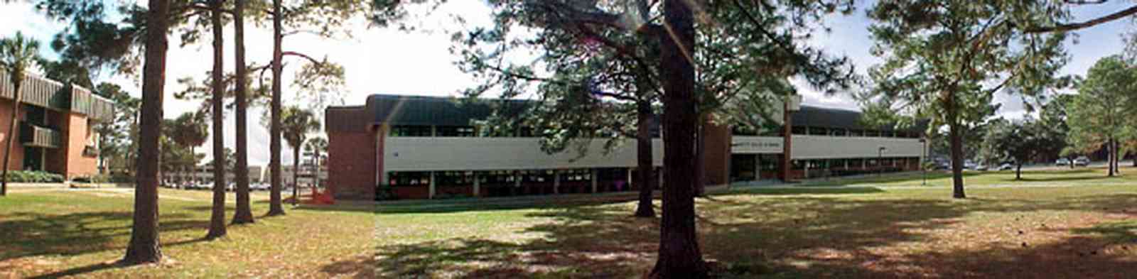 Pensacola:-Pensacola-Junior-College_04.jpg:  campus building, pine tree, college student
