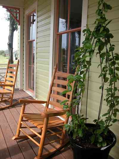 Pensacola:-Seville-Historic-District:-202-Cevallos-Street_03.jpg:  front porch, floor length windows, rocking chair, victorian cottage wood siding