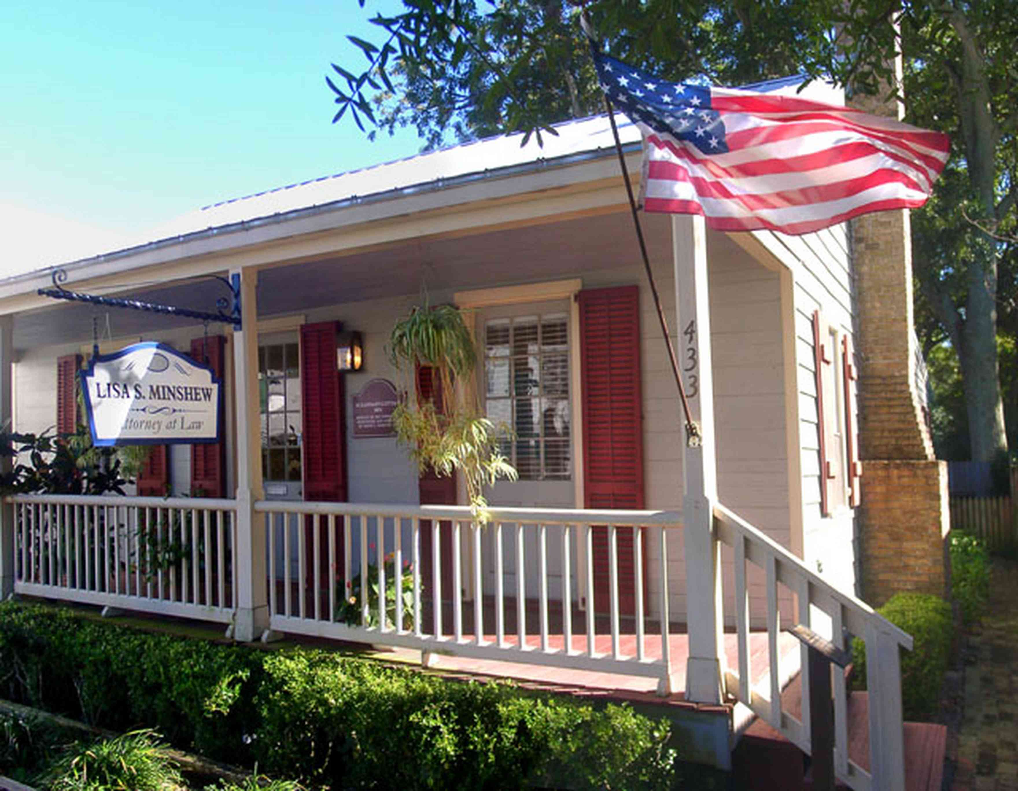 Pensacola:-Seville-Historic-District:-Lisa-Minshew-Attorney_00.jpg:  creole cottage, american flag, historic district, law office, columns, porch, wooden