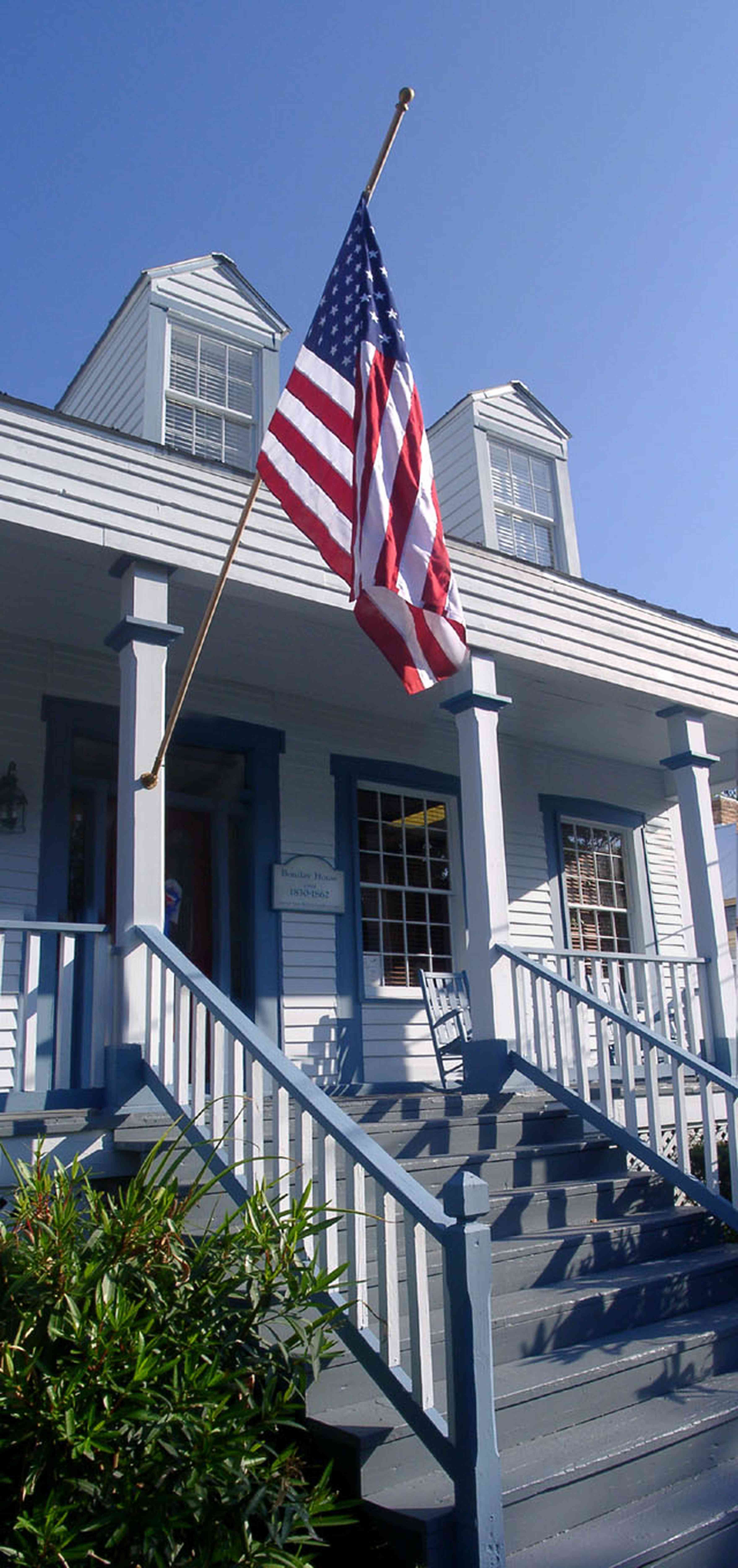 Pensacola:-Seville-Historic-District:-Michles-And-Booth-P.-A._0.jpg:  american flag, creole cottage, victorian cottage