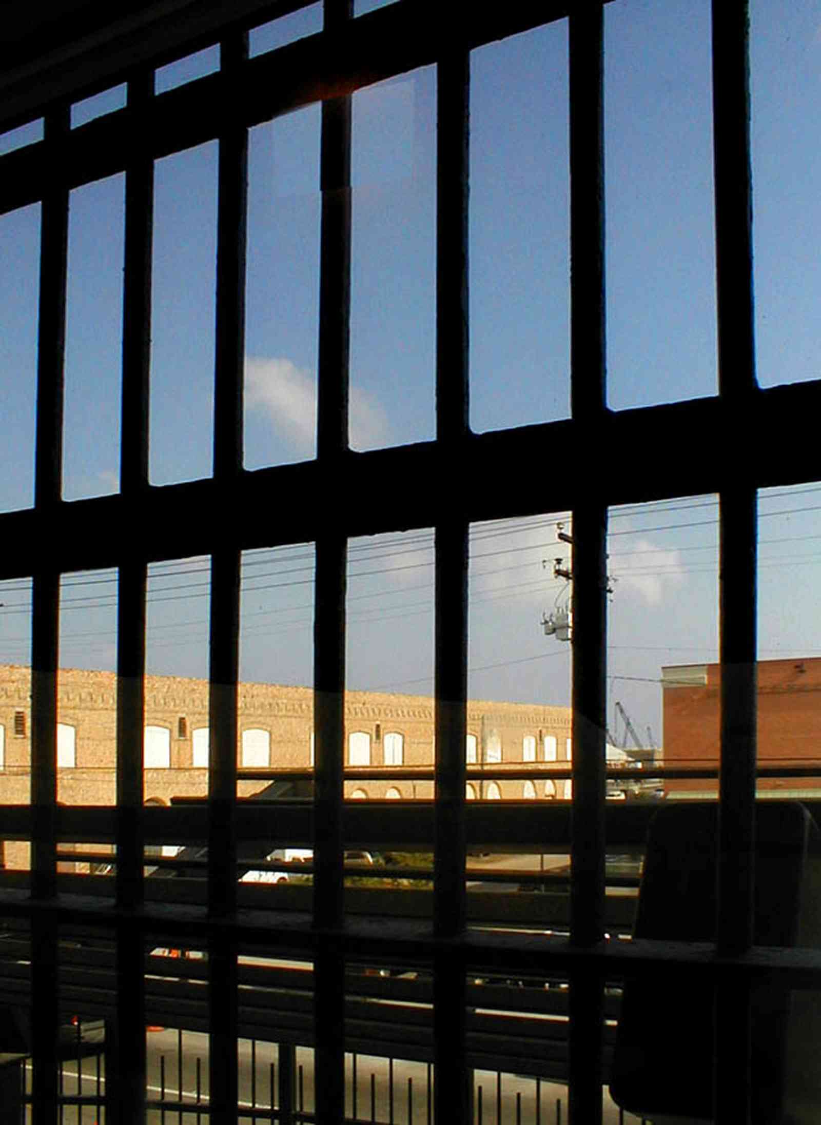 Pensacola:-Seville-Historic-District:-Old-City-Jail_13.jpg:  prisoner, jail, behind bars, barred windows, police department, city court, spanish revival building, pensacola museum of art