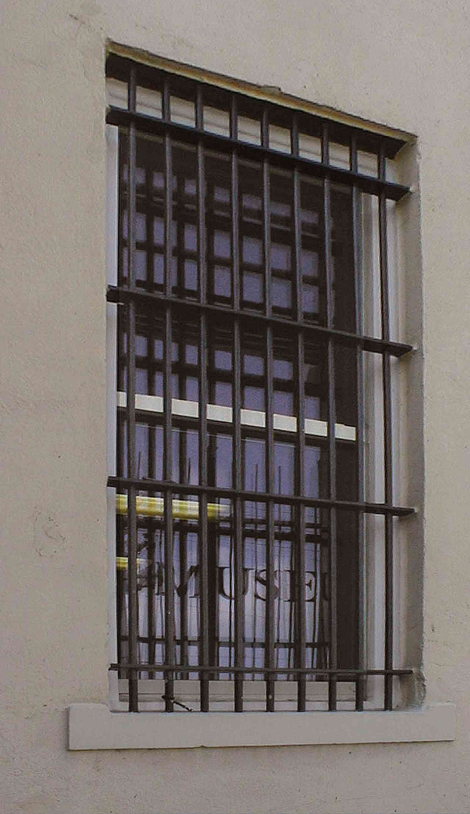 Pensacola:-Seville-Historic-District:-Old-City-Jail_13a.jpg:  prisoner, jail, behind bars, barred windows, police department, city court, spanish revival building, pensacola museum of art