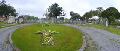 Pensacola:-Seville-Historic-District:-St-Michael-Cemetery_11.jpg:  cross, cemetery, oak trees, raised crypt, tomb
