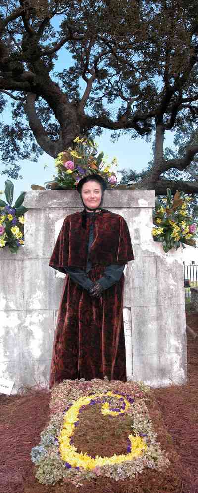 Pensacola:-Seville-Historic-District:-St-Michael-Cemetery_32.jpg:  floral tribute, velvet dress, gravesite, bonnet, oak tree, grave marker, monument