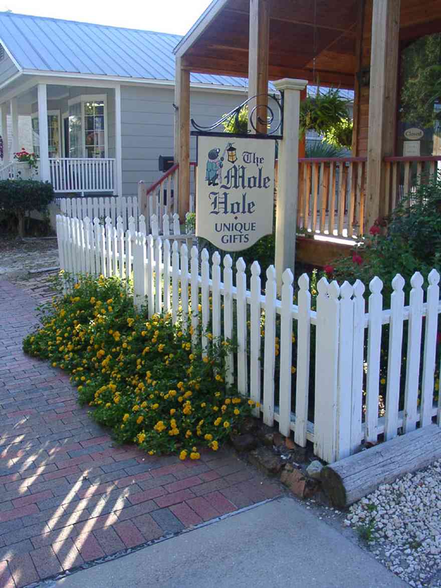 Pensacola:-Seville-Historic-District:-The-Mole-Hole_01.jpg:  picket fence, shop, shotgun cottage, historic district