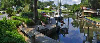 409+Montrose+Blvd-front+yard_04.jpg:  lake, flagstone, bench, boat house, oak tree, Gulf Breeze, 