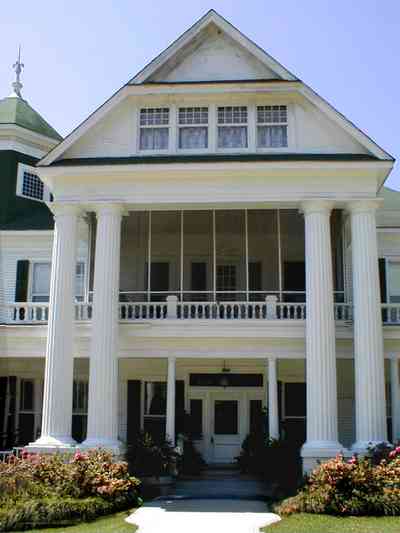 Brewton:-Belleville-Avenue_03.jpg:  victorian mansion, front porch, greek revival facade, classical revival, columns, azalea bushes, turret, colonnade, ionic columns, dormer window, side porch, 