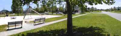 Cantonment:-Milestone_22.jpg:  cumulus clouds, oak trees, boulevard, tract houses, park, park bench, playground, slide,  garden