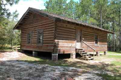 Cantonment:-Roy-Hyatt-Environmental-Center-Schoolhouse_02.jpg:  school, one-room schoolhouse, log cabin, pine trees, shake roof, wooden roof, cabin in the woods, single-pen house