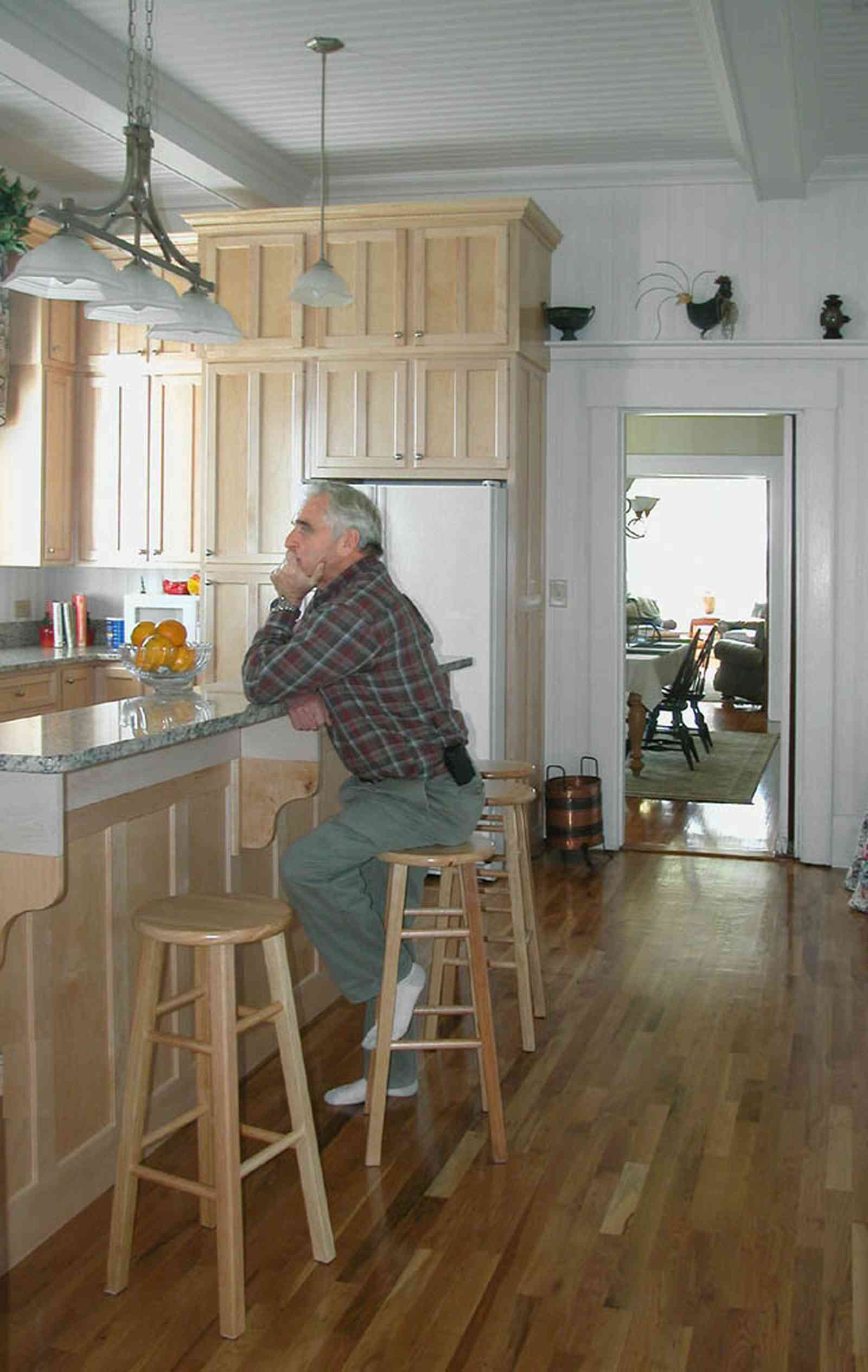 Century:-Tannenheim_01g.jpg:  kitchen counter, kitchen stools, granite counter tops, refrigerator, wooden floor, 