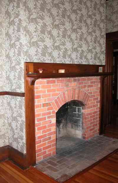 Century:-Tannenheim_01o.jpg:  fireplace, brick fireplace, damask wallpaper, wooden floor, heart pine flooring, mansion, plantation house