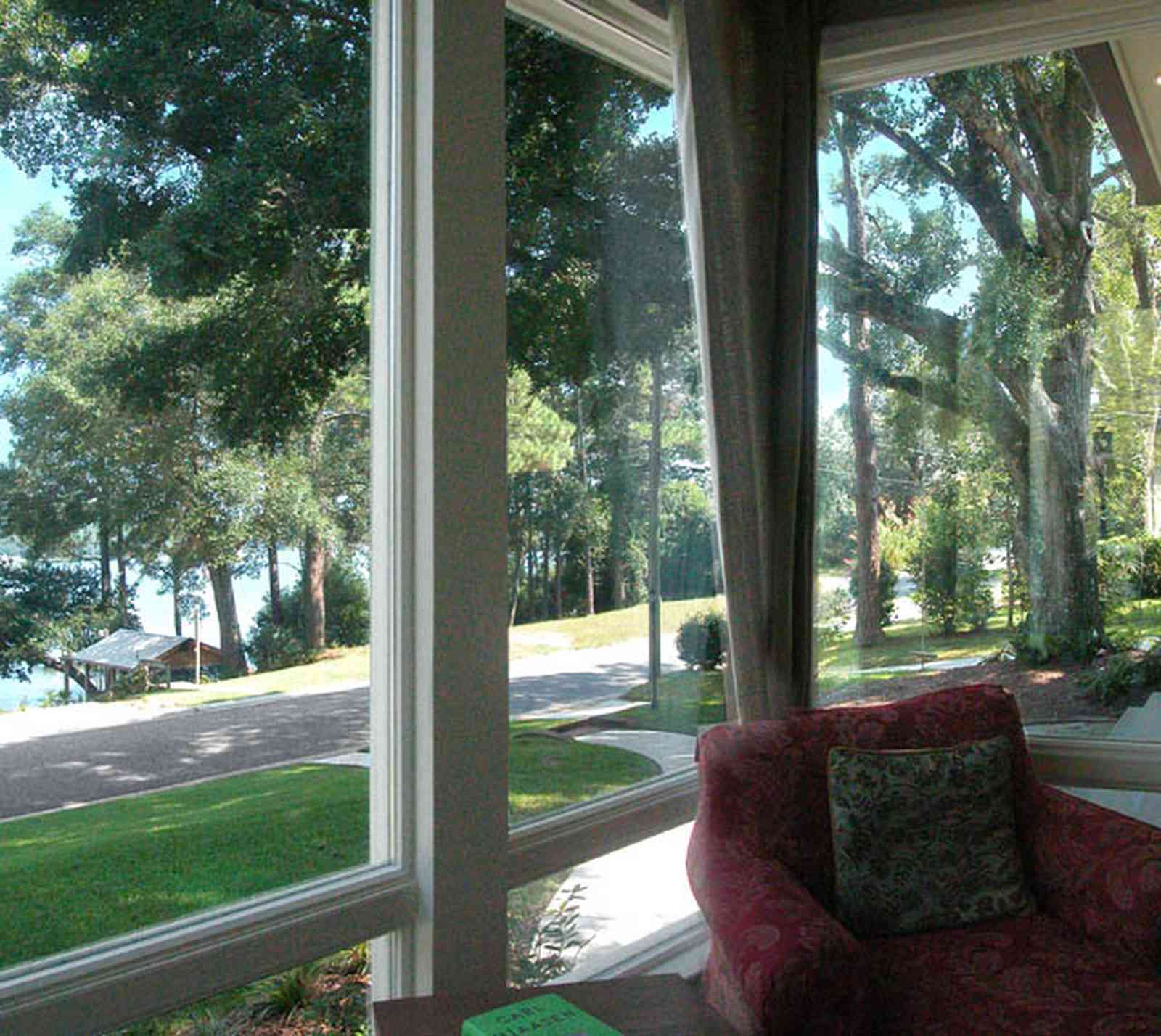 East-Hill:-2109-Whaley-Drive_07.jpg:  bayou texar, front room, porch, oak tree, green lawn, easy chair