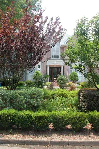 East-Hill:-617-19th-Avenue_03.jpg:  boxwood hedges, butterfly bush, italienate architecture, ferns, pediment, columns