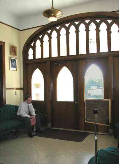 East-Hill:-Tower-East:-Old-Sacred-Heart-Hospital_35a.jpg:  front door, reception area, sofa, granite floor, clestory tracery, gothic revivial architectural style, beveled glass window